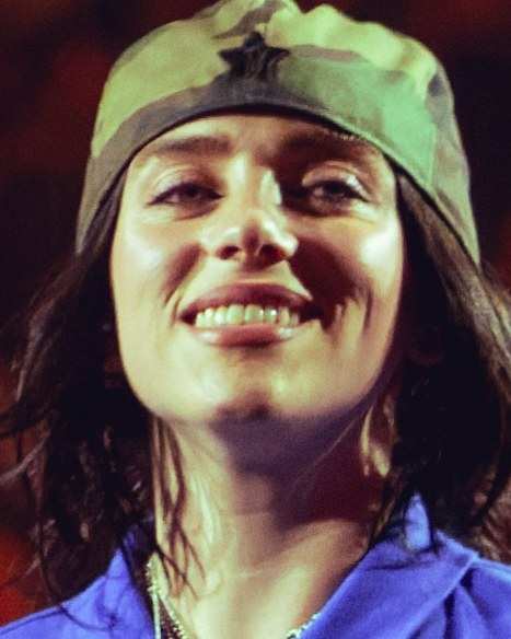 Billie Eilish smiling on stage in London in 2025