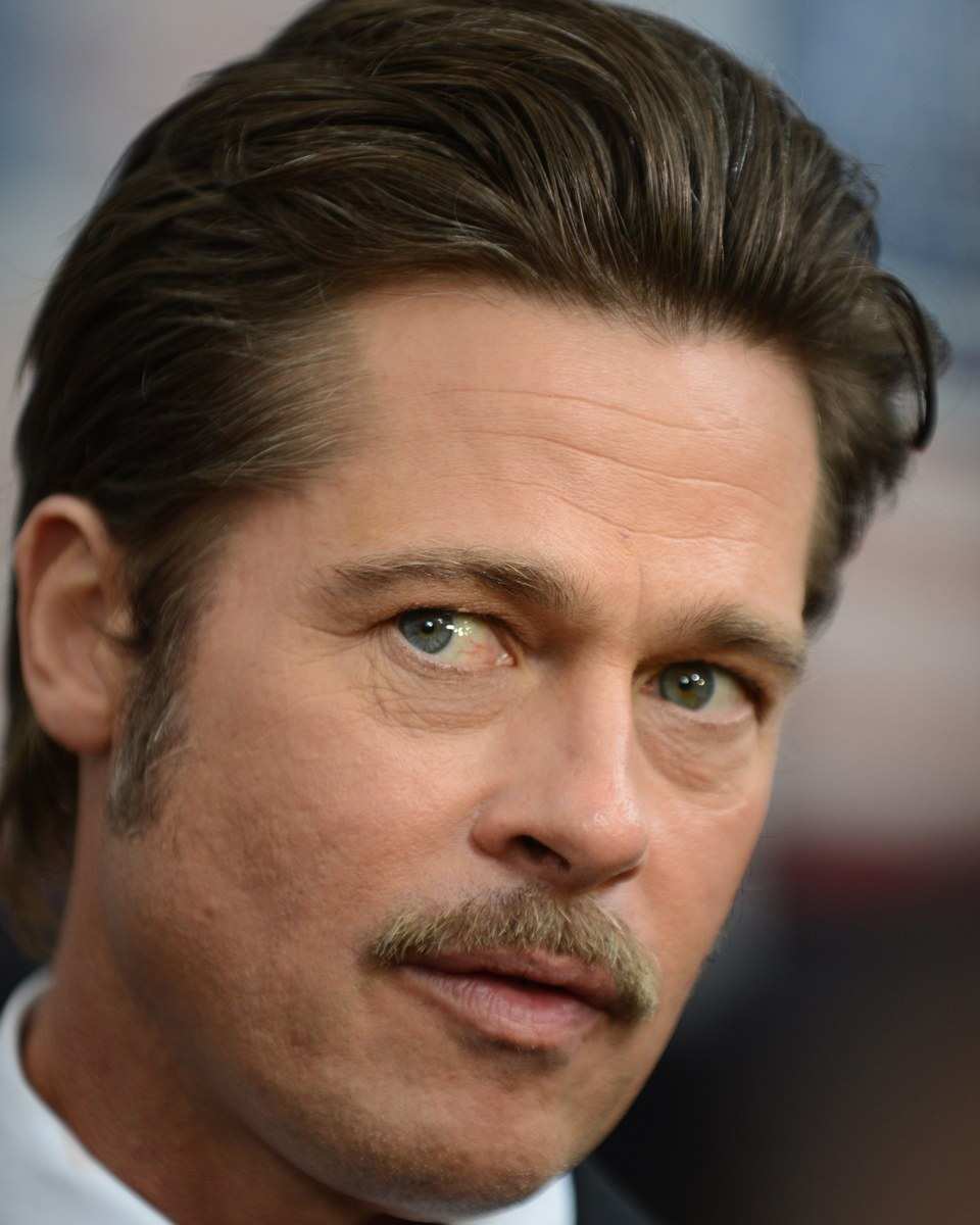 Brad Pitt with swept-back hair and a mustache at the Fury premiere in 2014