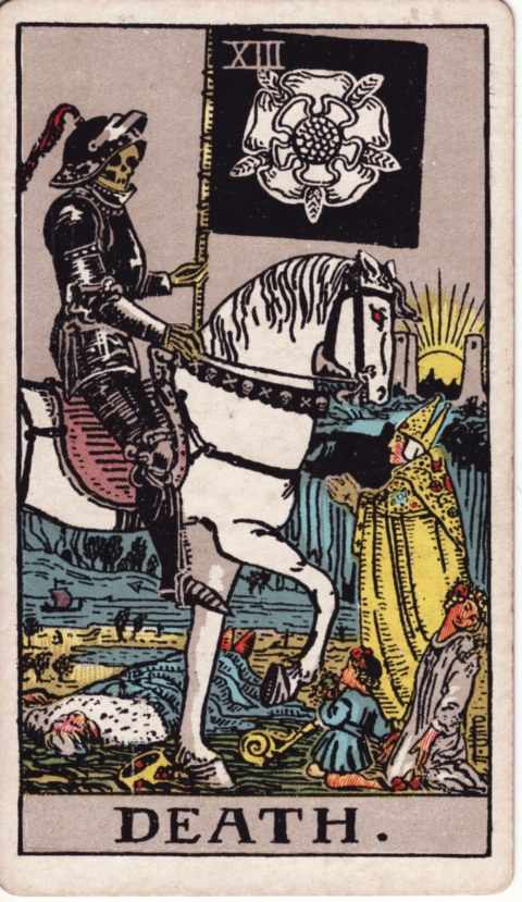 The Death card of the Rider–Waite–Smith deck: a skeleton in black armor rides a white horse and carries a black banner with a white rose, a king lies fallen, a bishop, a young woman and a child face him, a sun rises between two towers behind