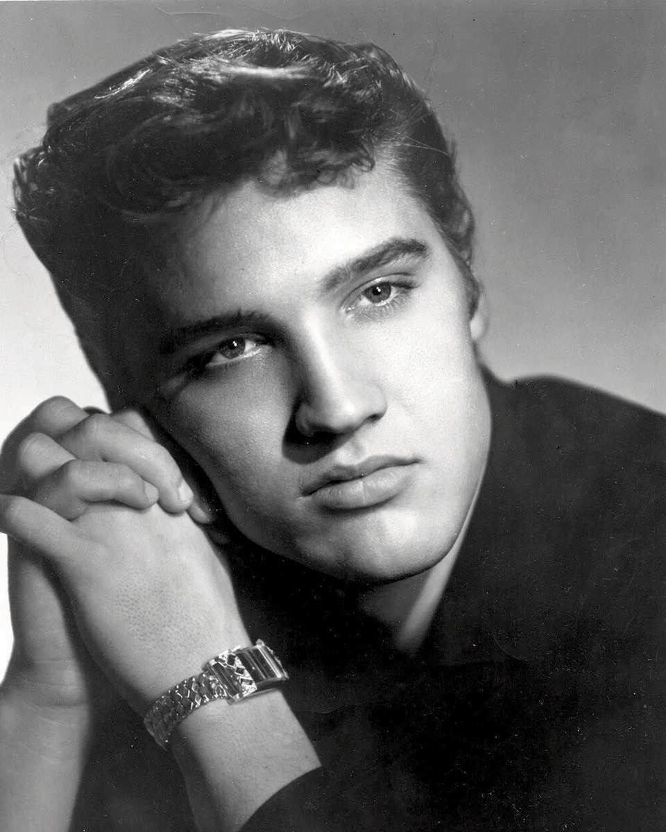 Elvis Presley in a black-and-white promotional portrait from 1955