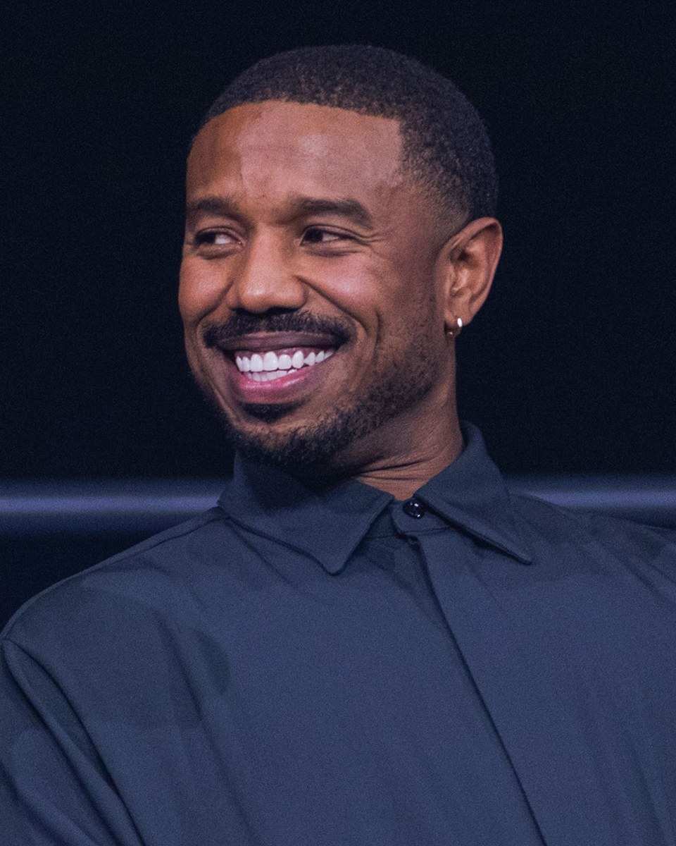Michael B. Jordan smiling at a Q&A for Sinners in 2025