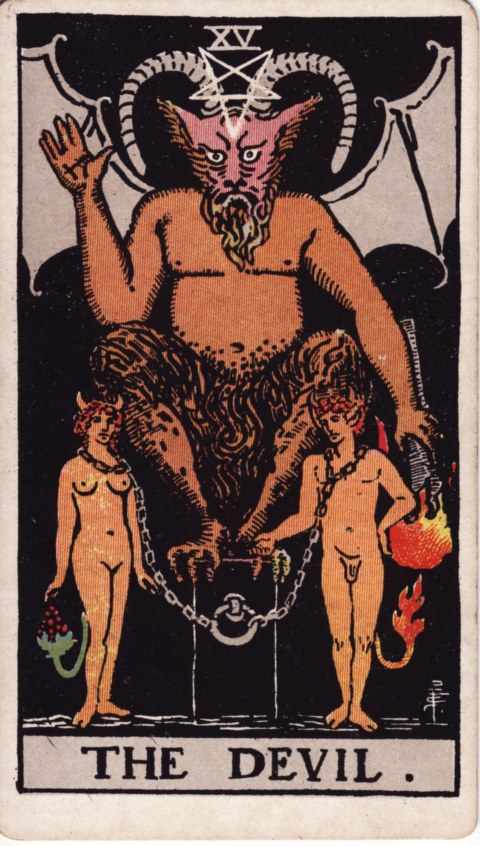 The Devil card of the Rider–Waite–Smith deck: a horned, goat-headed figure with bat wings and an inverted pentagram on the forehead squats on a black pedestal, right hand raised and a torch pointed down in the left, while a naked man and woman with small horns and tails stand chained to the pedestal
