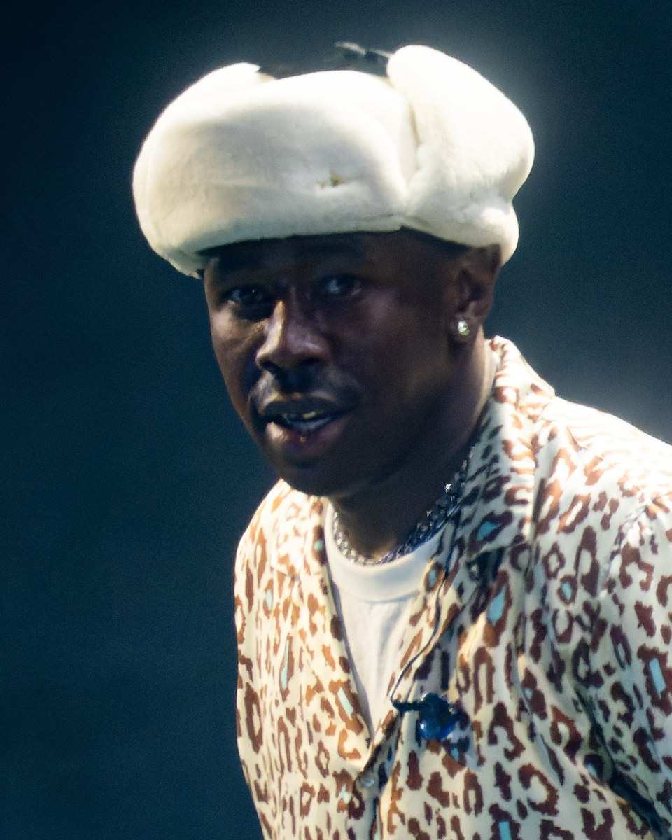 Tyler, the Creator in a fur hat on stage in 2022